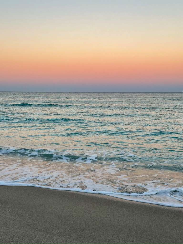 Pastel sunset over gentle waves on Hollywood beach